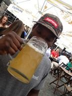 black boy drinking beer from the glass