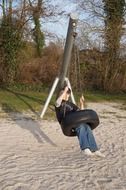 boy swinging on tire swing