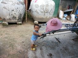 thai baby boy holding arms outdoor