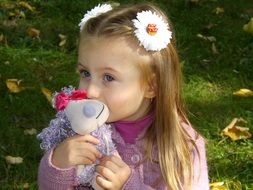 girl kisses a plush toy