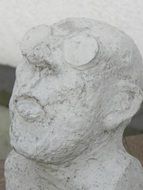 stone sculpture of a man with glasses