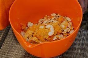 pumpkin fresh seeds in Orange bowl