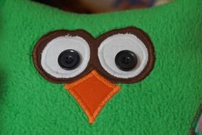 green pillow with owl face