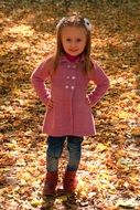 girl with blue eyes posing against the backdrop of autumn leaves