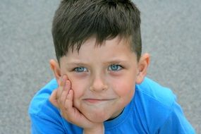 Portrait of a boy with blue eyes in a blue T-shirt