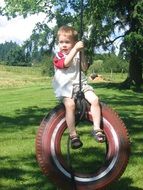 baby on a swing with a tire