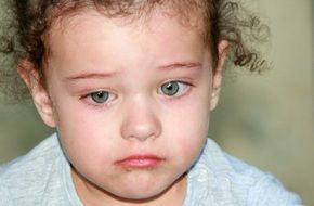 nice blue-eyed baby with curly hair