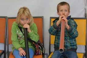 children blowing in the pipe