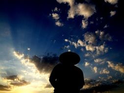 silhouette of a man against the colorful sky in the sunset