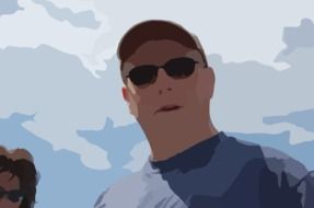 silhouette of a man in black glasses against a blue sky