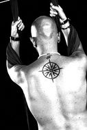 male back with star of the winds tattoo