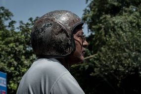 Man in old bike helmet