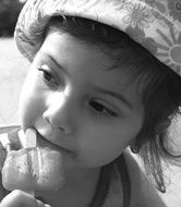 black and white portrait of a little girl with ice cream