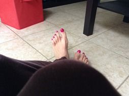 pink pedicure on the toes of a girl