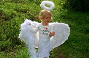 a child with white angel wings of feathers