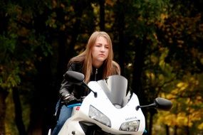 riding on a motorcycle of biker girl in a leather jacket