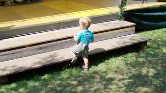 toddler boy on wooden stairs