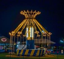 bright carousel in amusement park at night