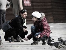 people feeding pigeons on the street in Colombo