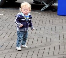 little boy with white hair in the street