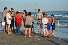 group of people on sunny sand beach