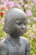 bronze sculpture of a girl in the park