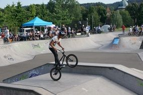 man jumping on a bicycle