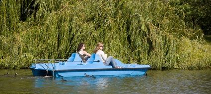 women ride a catamaran