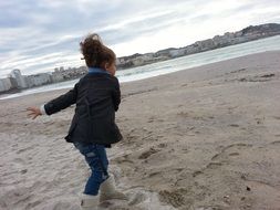 girl runs along the beach