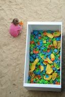 girl playing on the playground in the sand