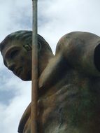 bronze man's head with a spear