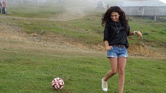 girl runs near the ball in countryside in Georgia