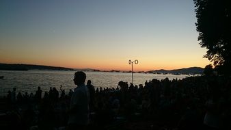 silhouettes on lake at sunset