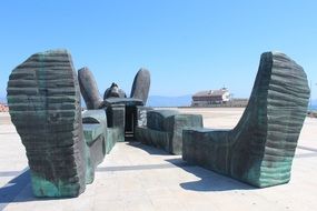 Giant man lying on sand, contemporary sculpture, spain, galicia