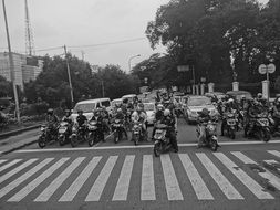 black and white photo of people on motorcycles