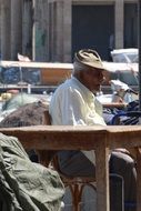 old man rest in a port