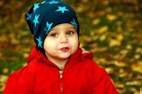 portrait of the child on the background of autumn nature in park