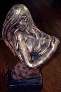 bronze figure of a girl with long hair