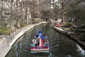 tourists on boat travelling by channel