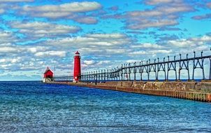 red lighthouse on the pier on lake michigan, usa