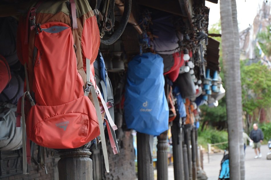 lot of backpacks for camping on piles