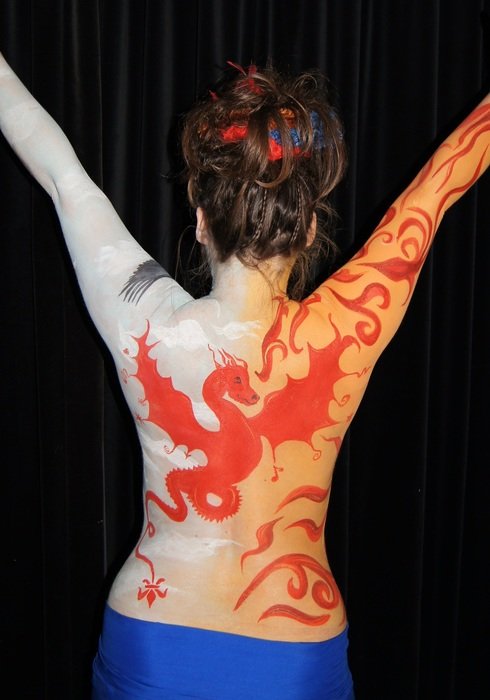 drawing a dragon on the back of a girl