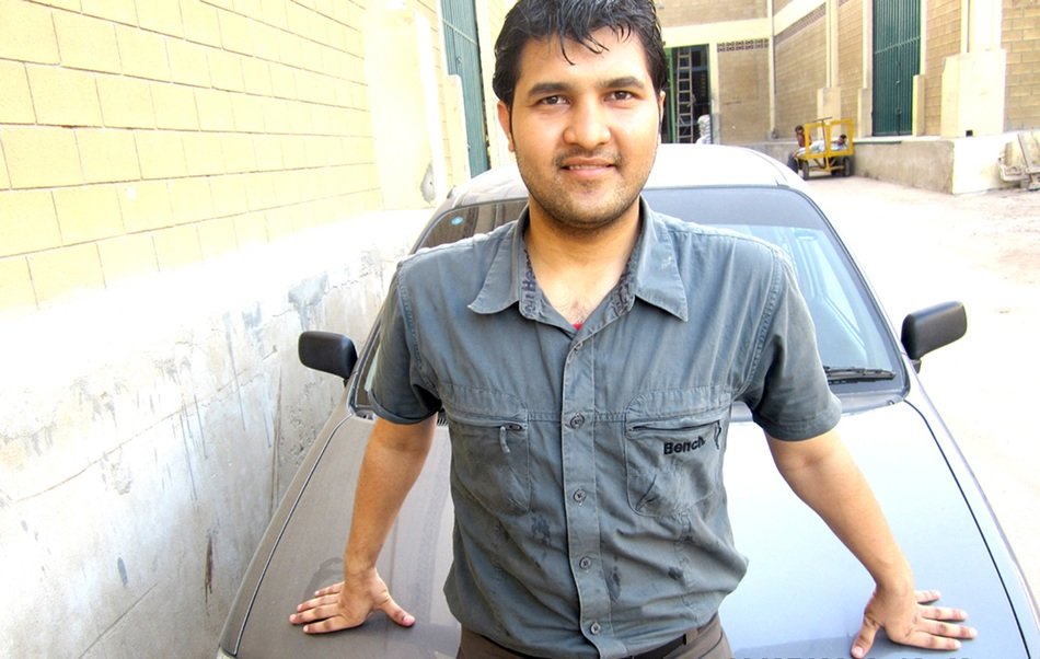 happy Indian man near the car