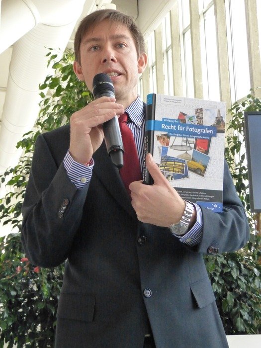 Lecturer with a microphone on a book presentation