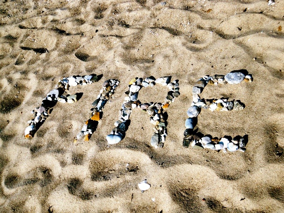 letters of shells on the sand