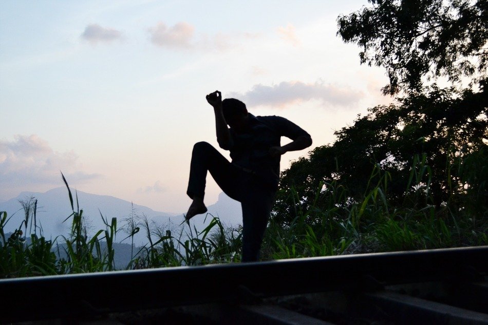 fighter engaged in thai boxing at sunset