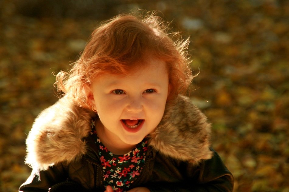 baby girl on the background of autumn leaves