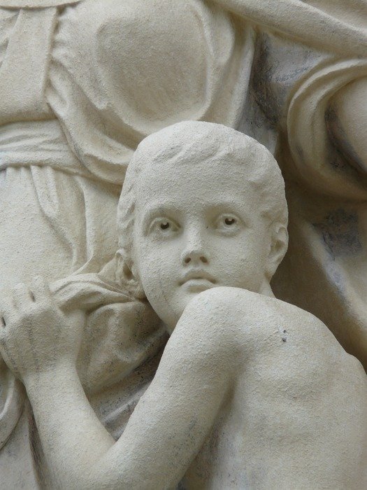 stone statue on the facade of the house