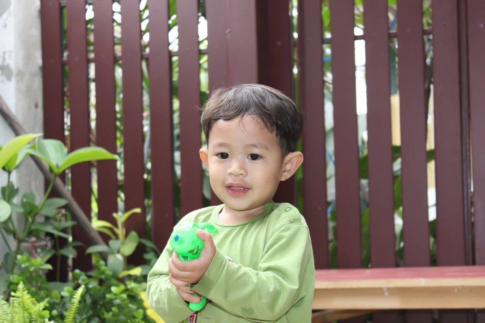 boy with a water gun in the yard