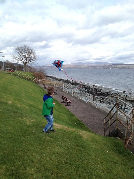 boy in the green jacket on the coast